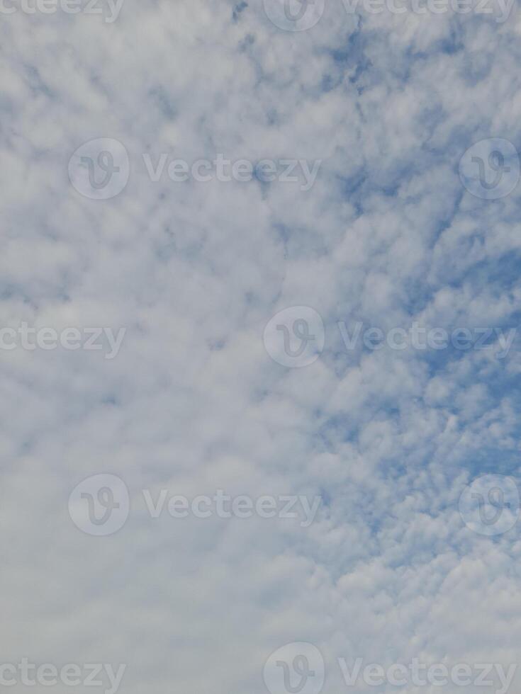 Beautiful white clouds on deep blue sky background. Large bright soft fluffy clouds are cover the entire blue sky. photo