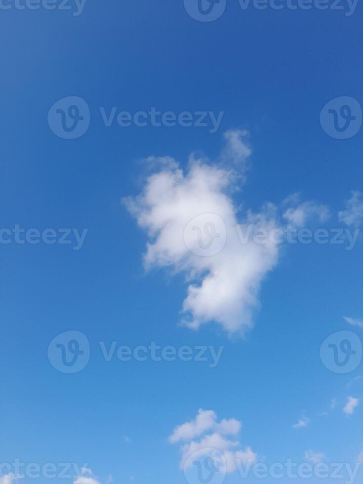 Beautiful white clouds on deep blue sky background. Large bright soft fluffy clouds are cover the entire blue sky. photo
