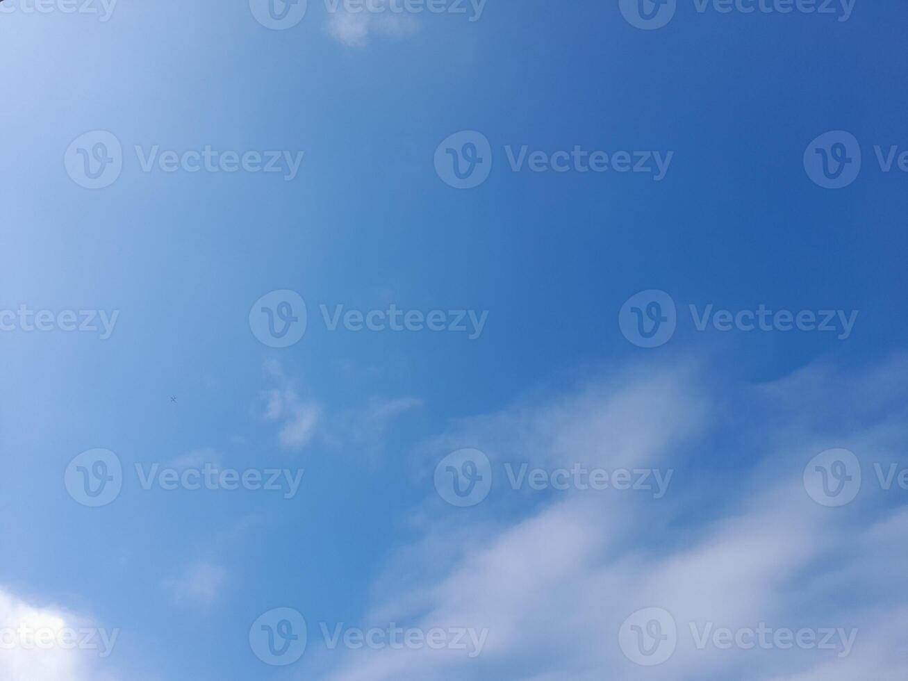 Beautiful white clouds on deep blue sky background. Large bright soft fluffy clouds are cover the entire blue sky. photo