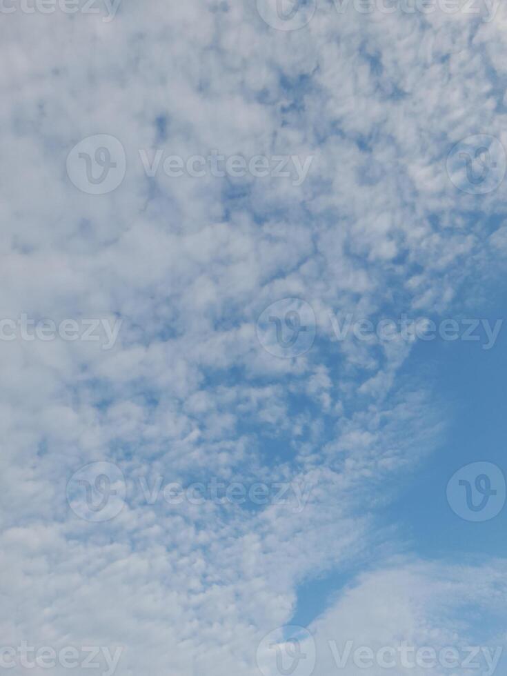 Beautiful white clouds on deep blue sky background. Large bright soft fluffy clouds are cover the entire blue sky. photo