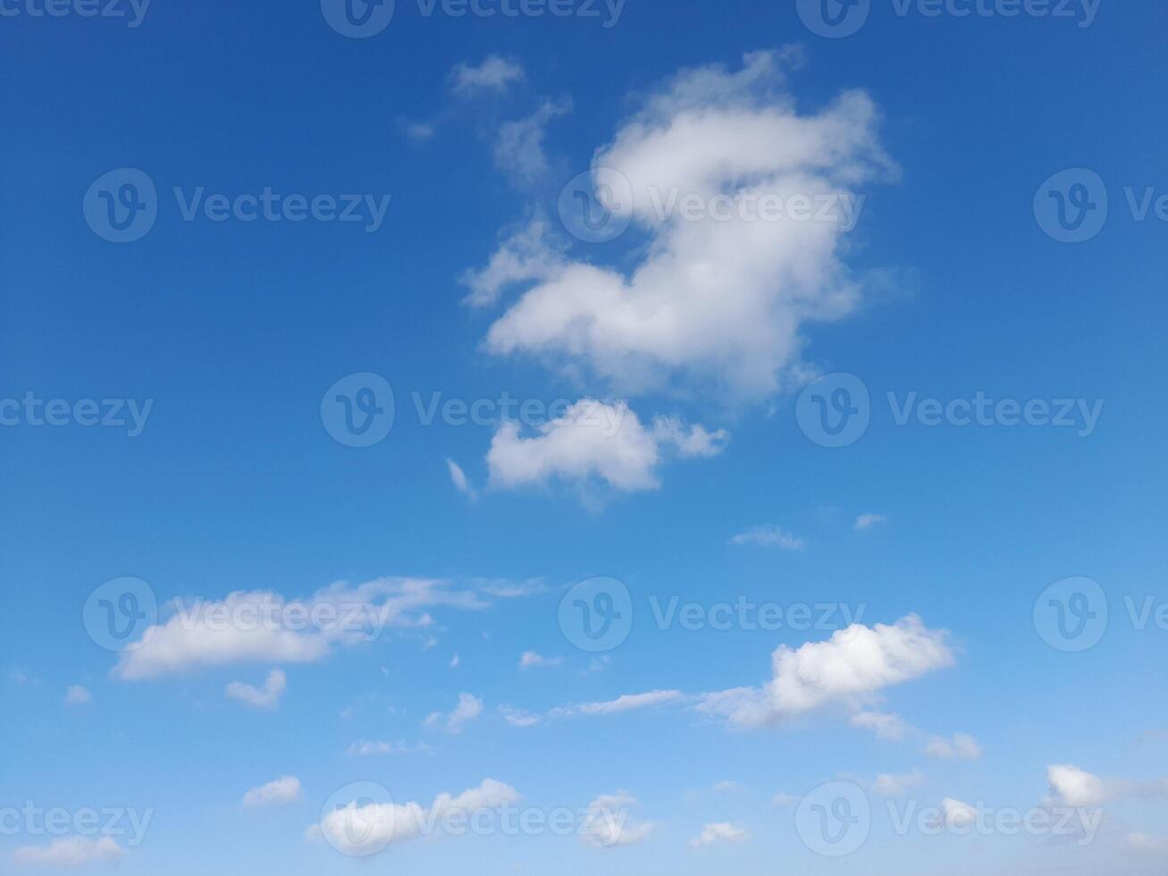 Beautiful white clouds on deep blue sky background. Large bright soft fluffy clouds are cover the entire blue sky. photo