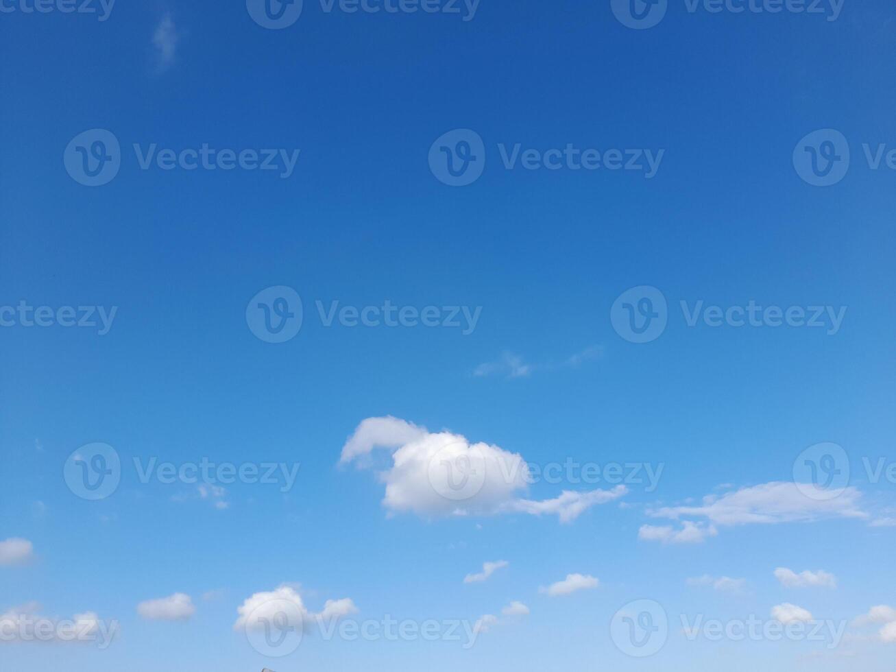 Beautiful white clouds on deep blue sky background. Large bright soft fluffy clouds are cover the entire blue sky. photo