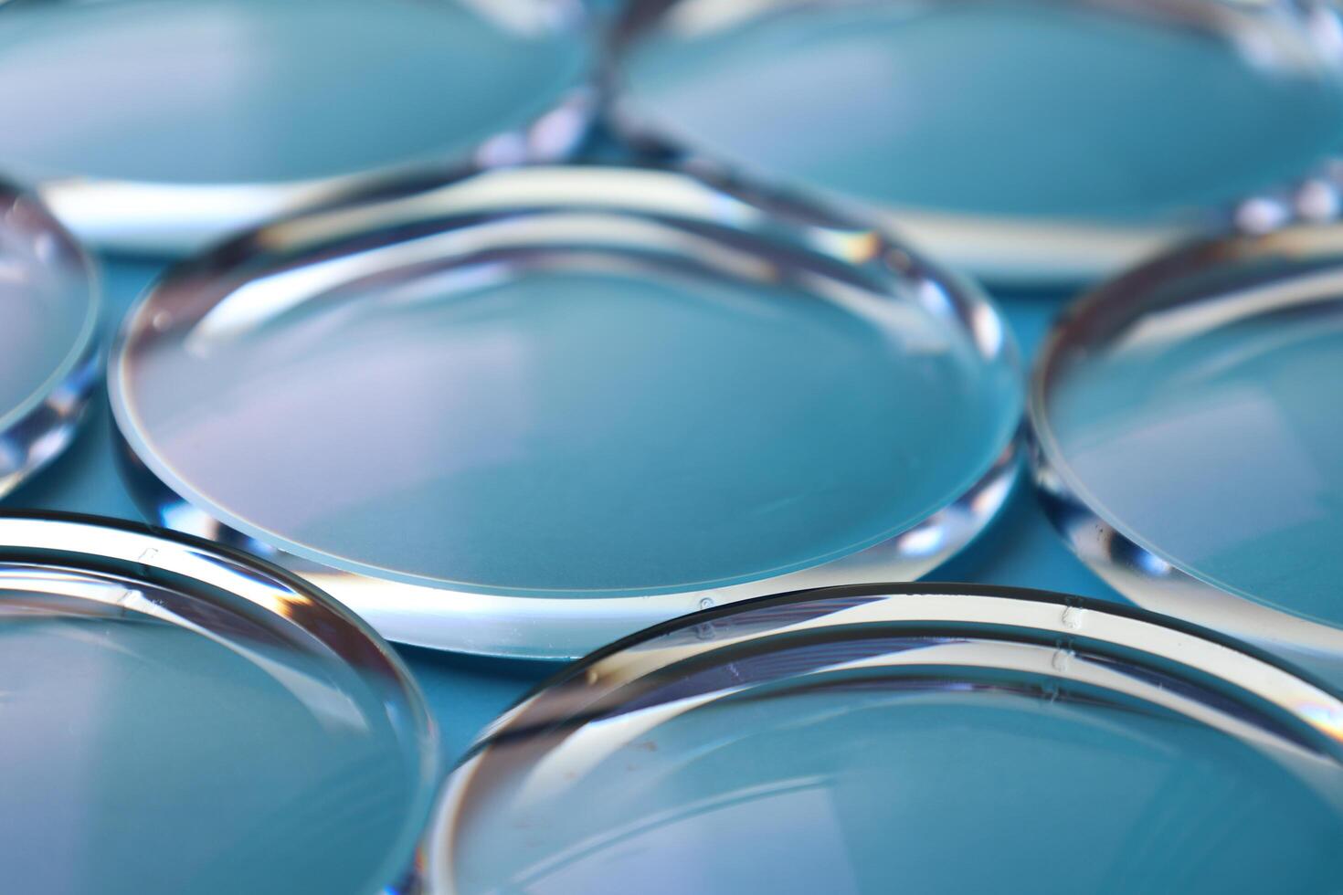 Eyeglasses lens production industry, close-up eyeglasses lenses, eyeglasses lenses, eyeglasses lenses, eyeglasses store business concept photo