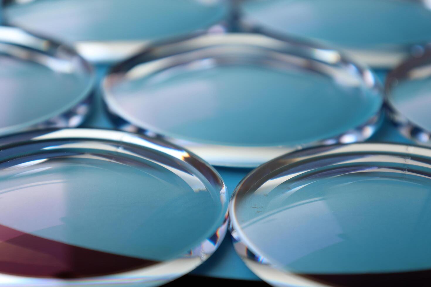 Eyeglasses lens production industry, close-up eyeglasses lenses, eyeglasses lenses, eyeglasses lenses, eyeglasses store business concept photo