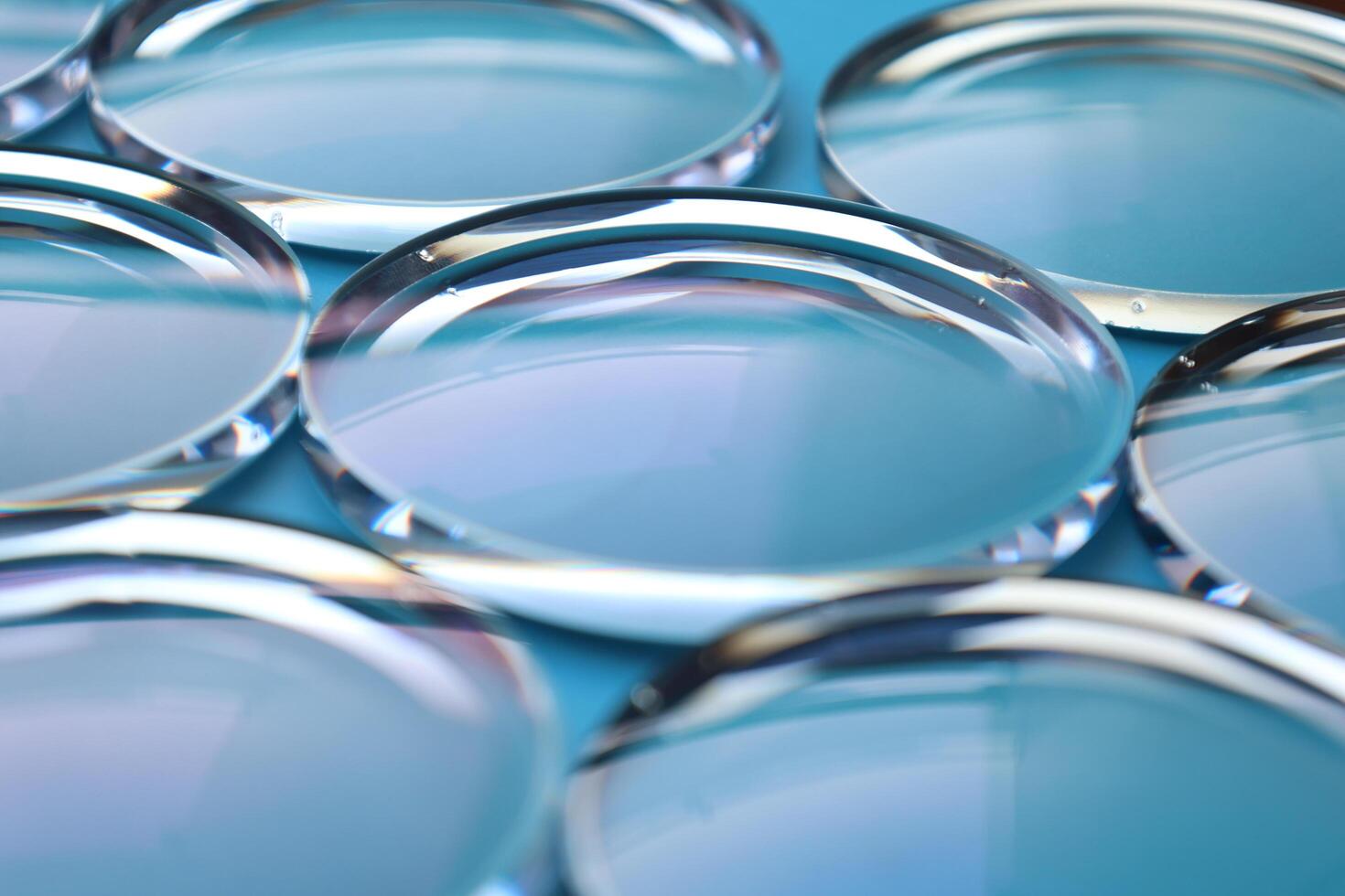 Eyeglasses lens production industry, close-up eyeglasses lenses, eyeglasses lenses, eyeglasses lenses, eyeglasses store business concept photo