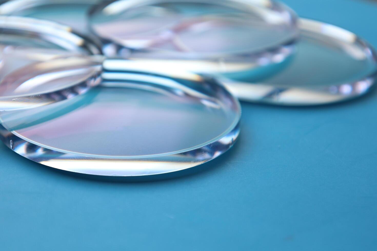 Eyeglasses lens production industry, close-up eyeglasses lenses, eyeglasses lenses, eyeglasses lenses, eyeglasses store business concept photo