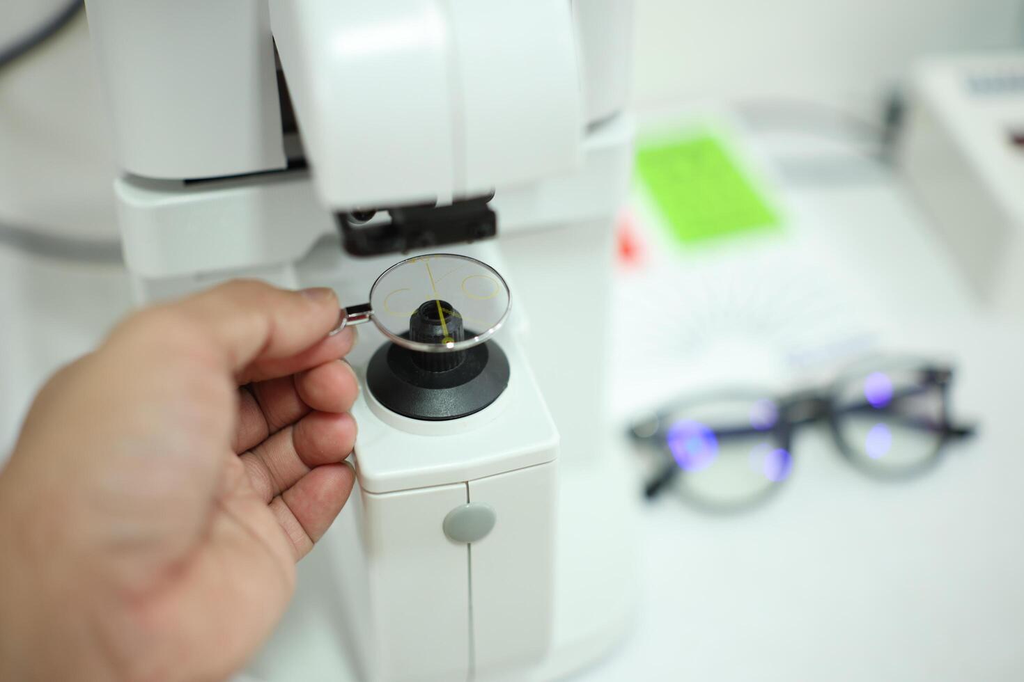 Hand holding eyeglasses in optical store photo