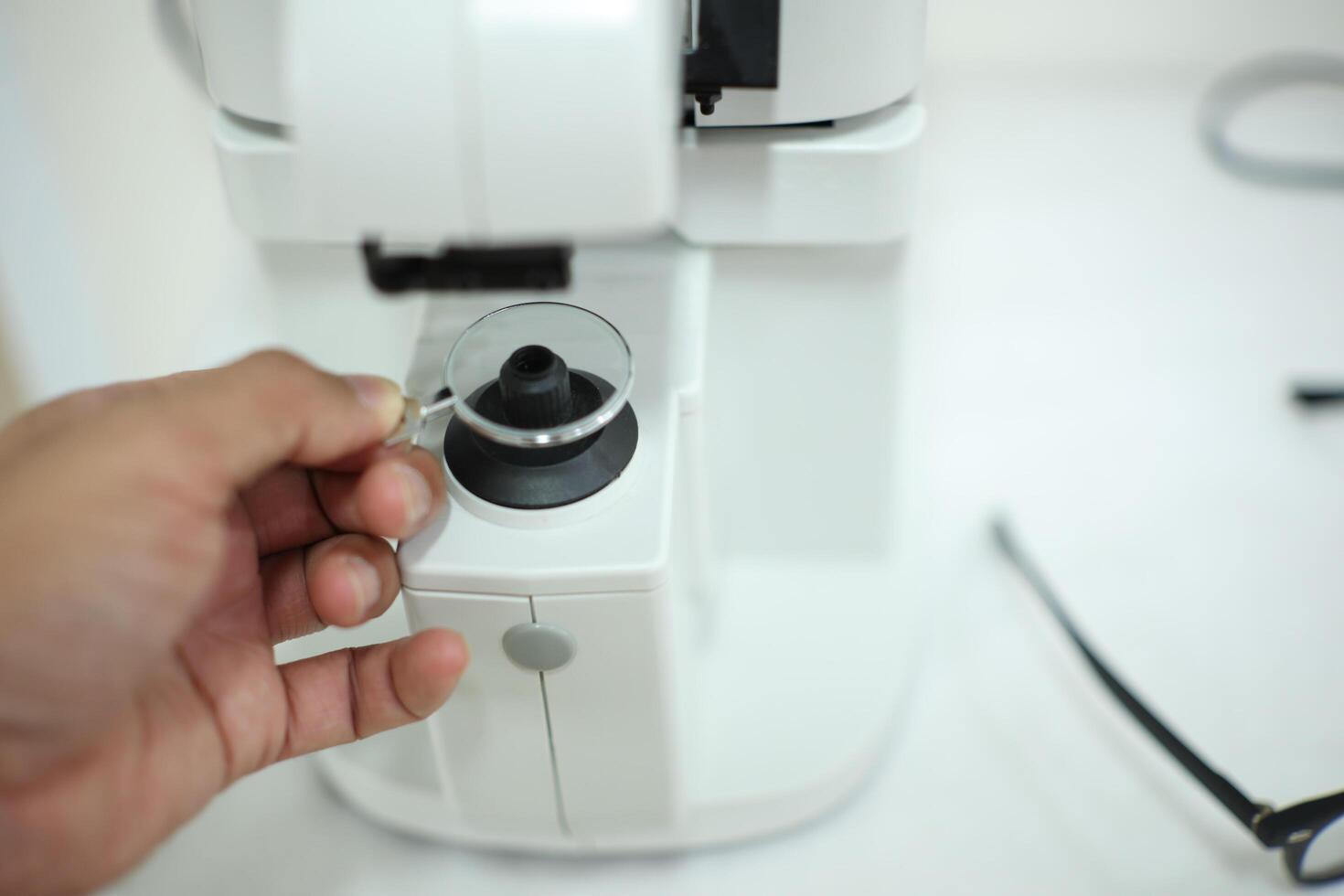 Hand holding eyeglasses in optical store photo