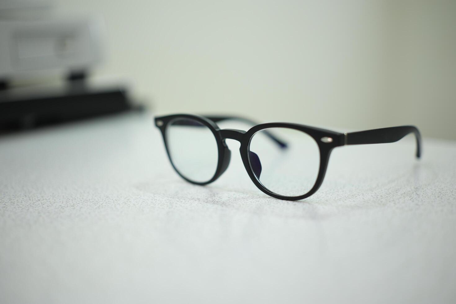 Hand holding eyeglasses in optical store photo
