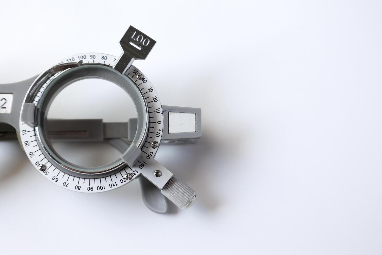 Trial frame glasses for eye test on chart in optical store photo