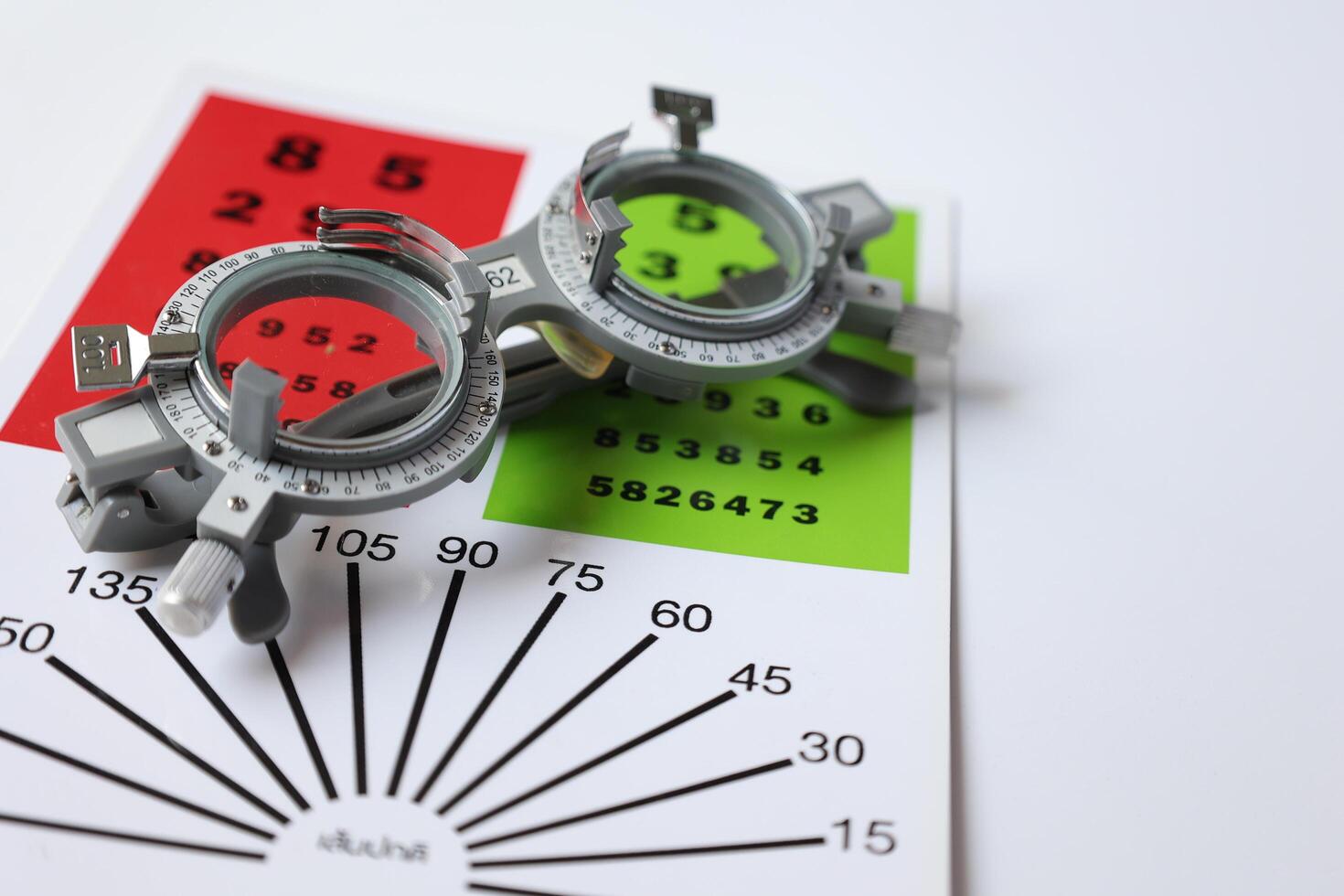 Trial frame glasses for eye test on chart in optical store photo