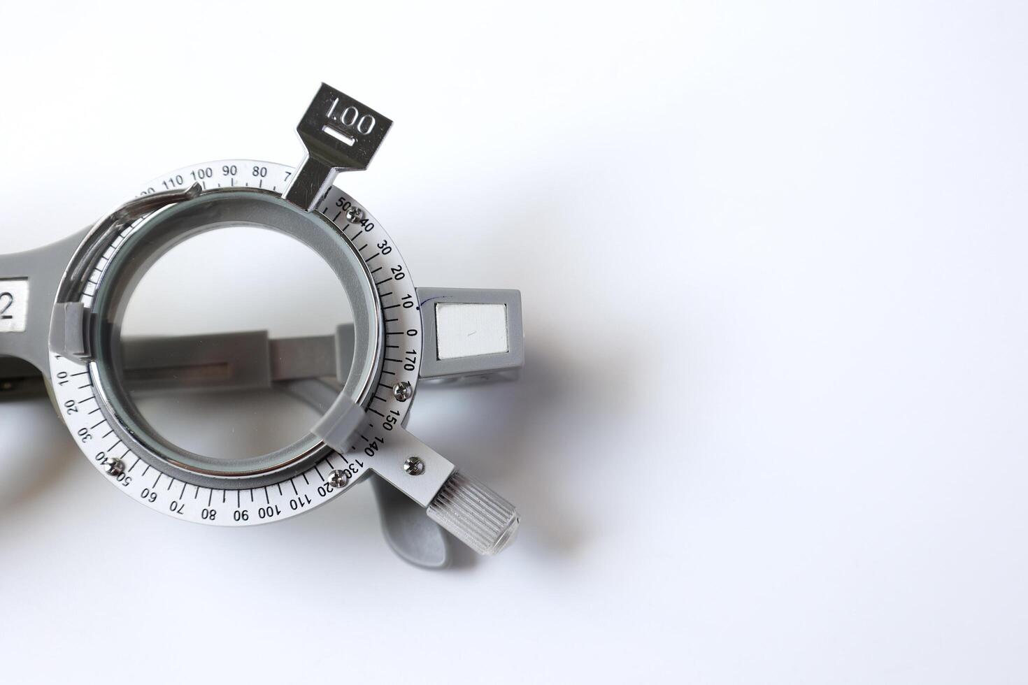 Trial frame glasses for eye test on chart in optical store photo