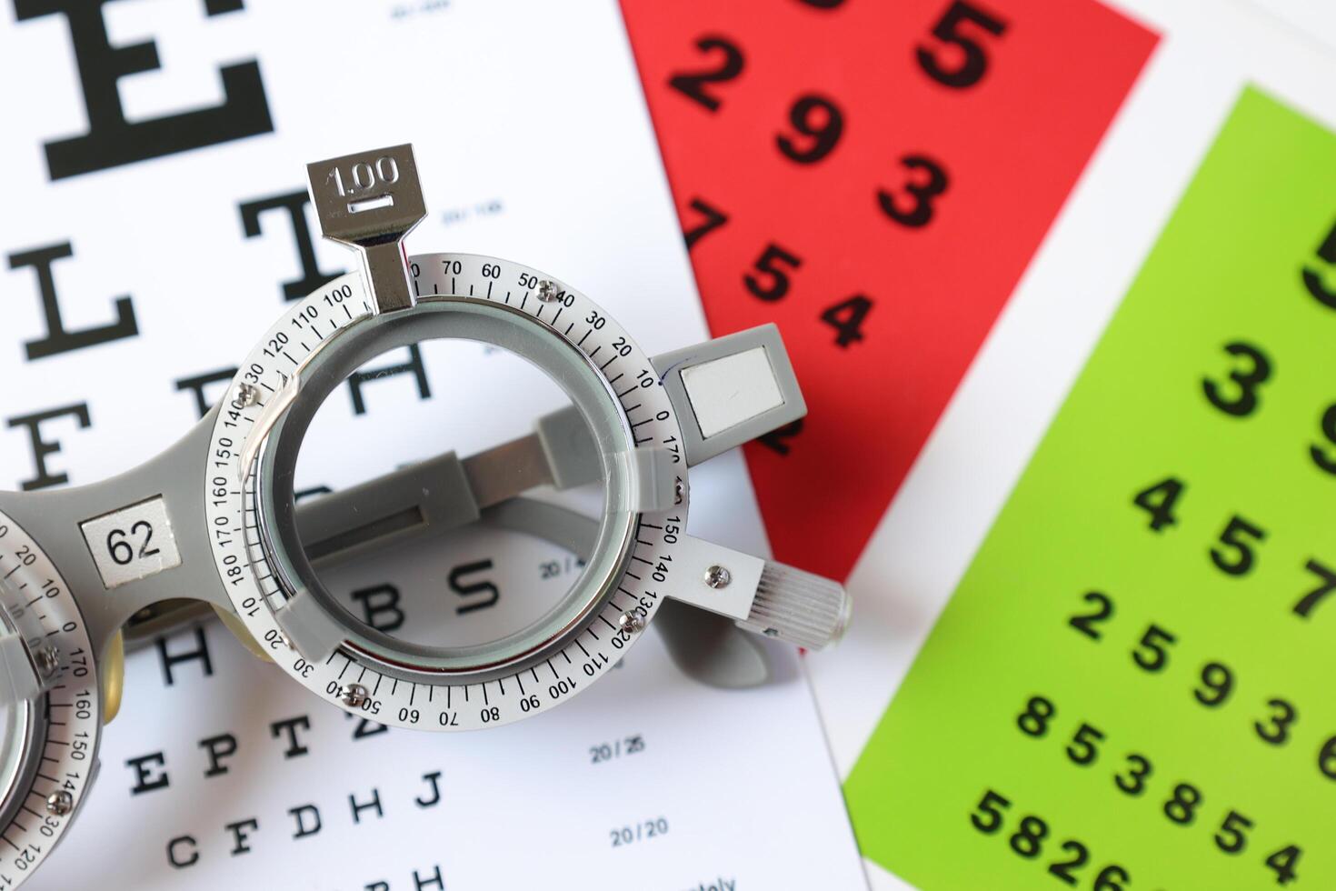 Trial frame glasses for eye test on chart in optical store photo