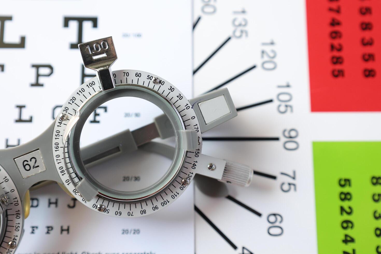 Trial frame glasses for eye test on chart in optical store photo