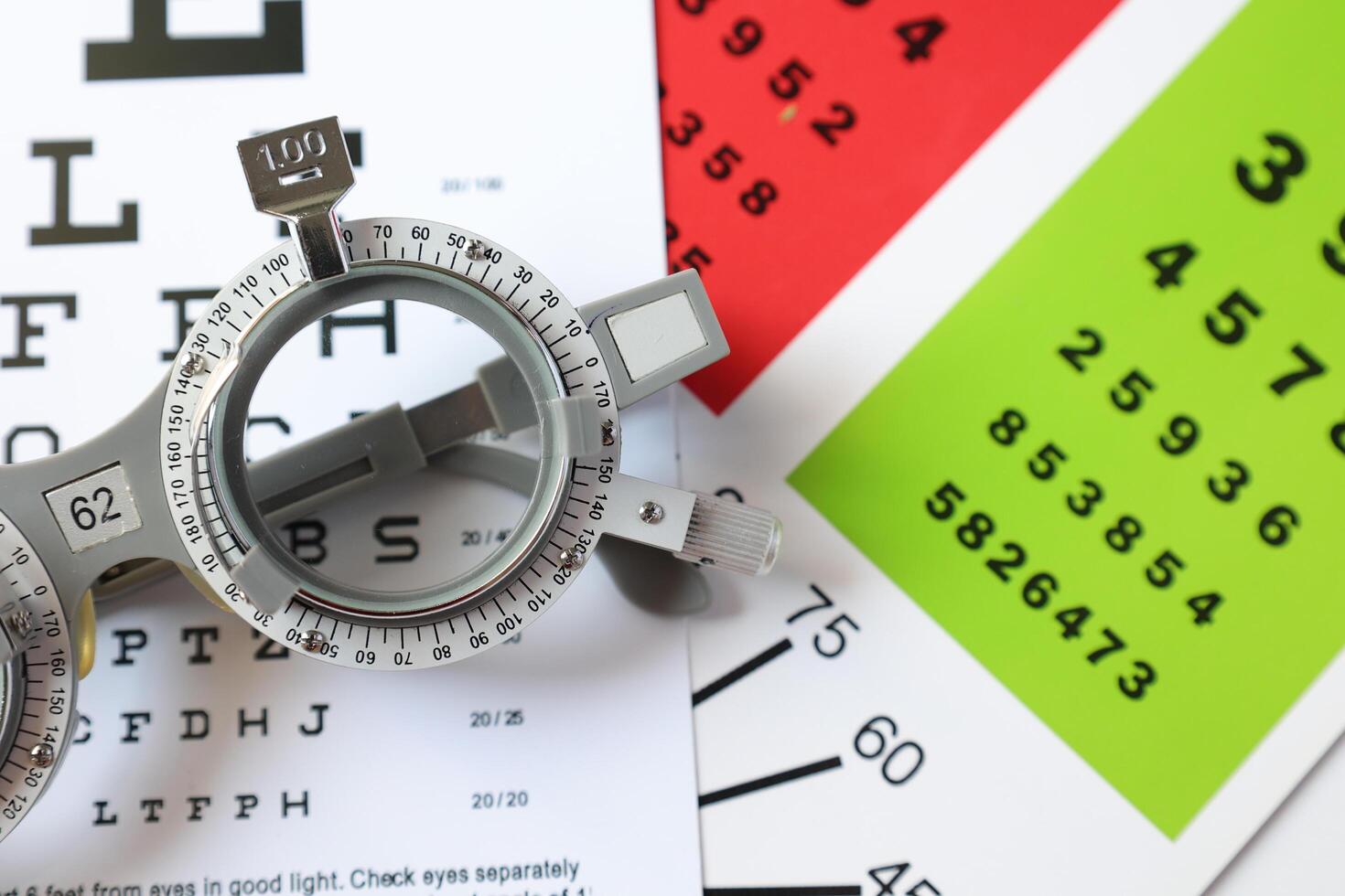 Trial frame glasses for eye test on chart in optical store photo