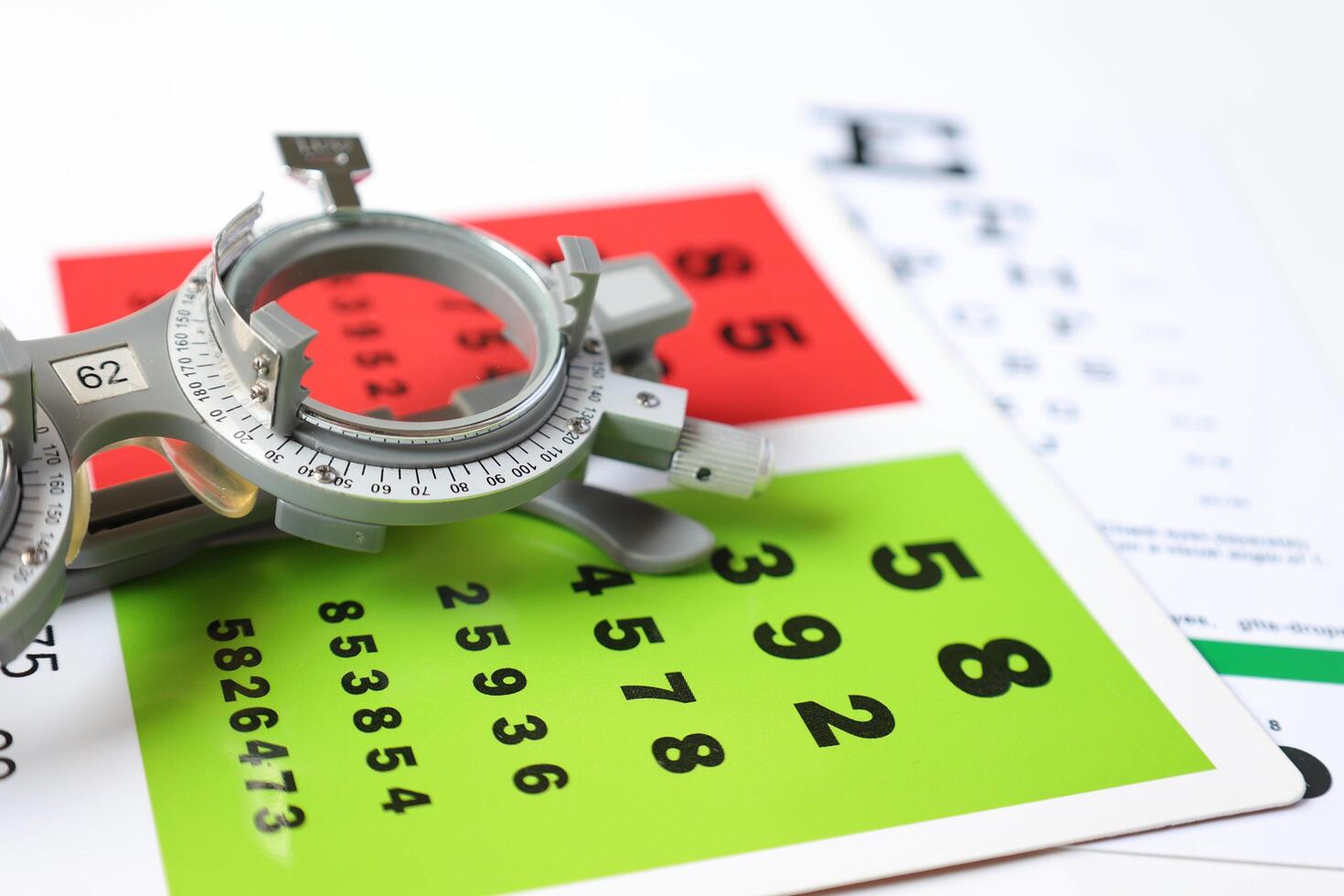 Trial frame glasses for eye test on chart in optical store photo