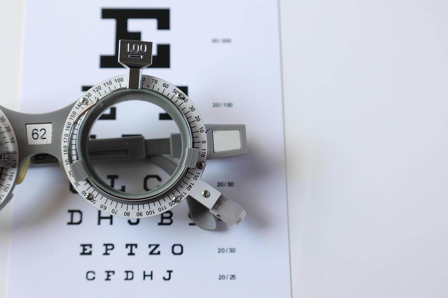 Trial frame glasses for eye test on chart in optical store photo