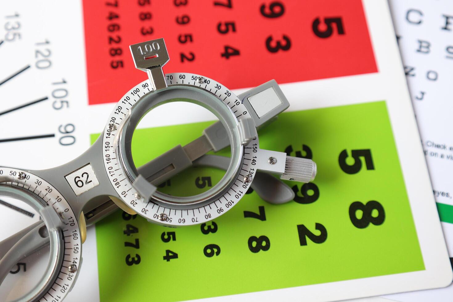 Trial frame glasses for eye test on chart in optical store photo
