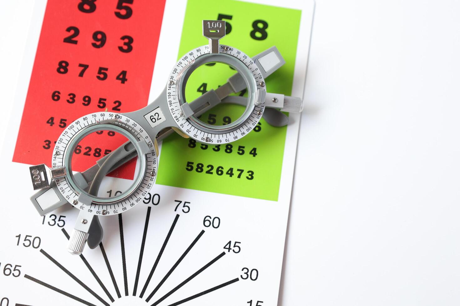 Trial frame glasses for eye test on chart in optical store photo