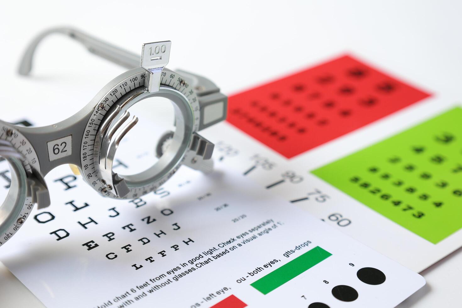 Trial frame glasses for eye test on chart in optical store photo