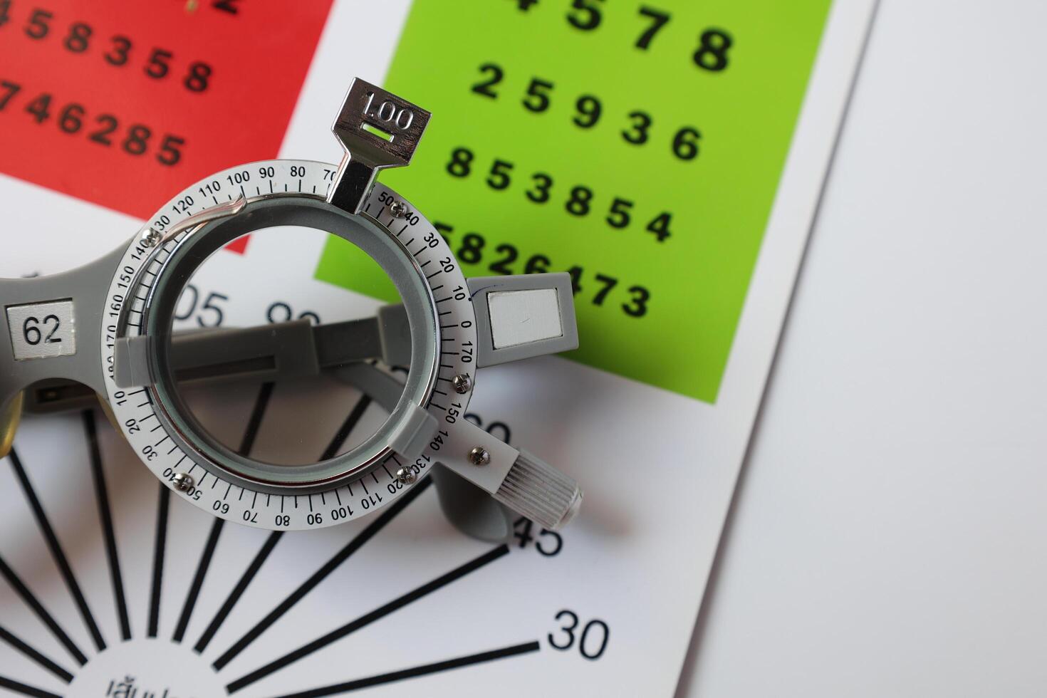 Trial frame glasses for eye test on chart in optical store photo