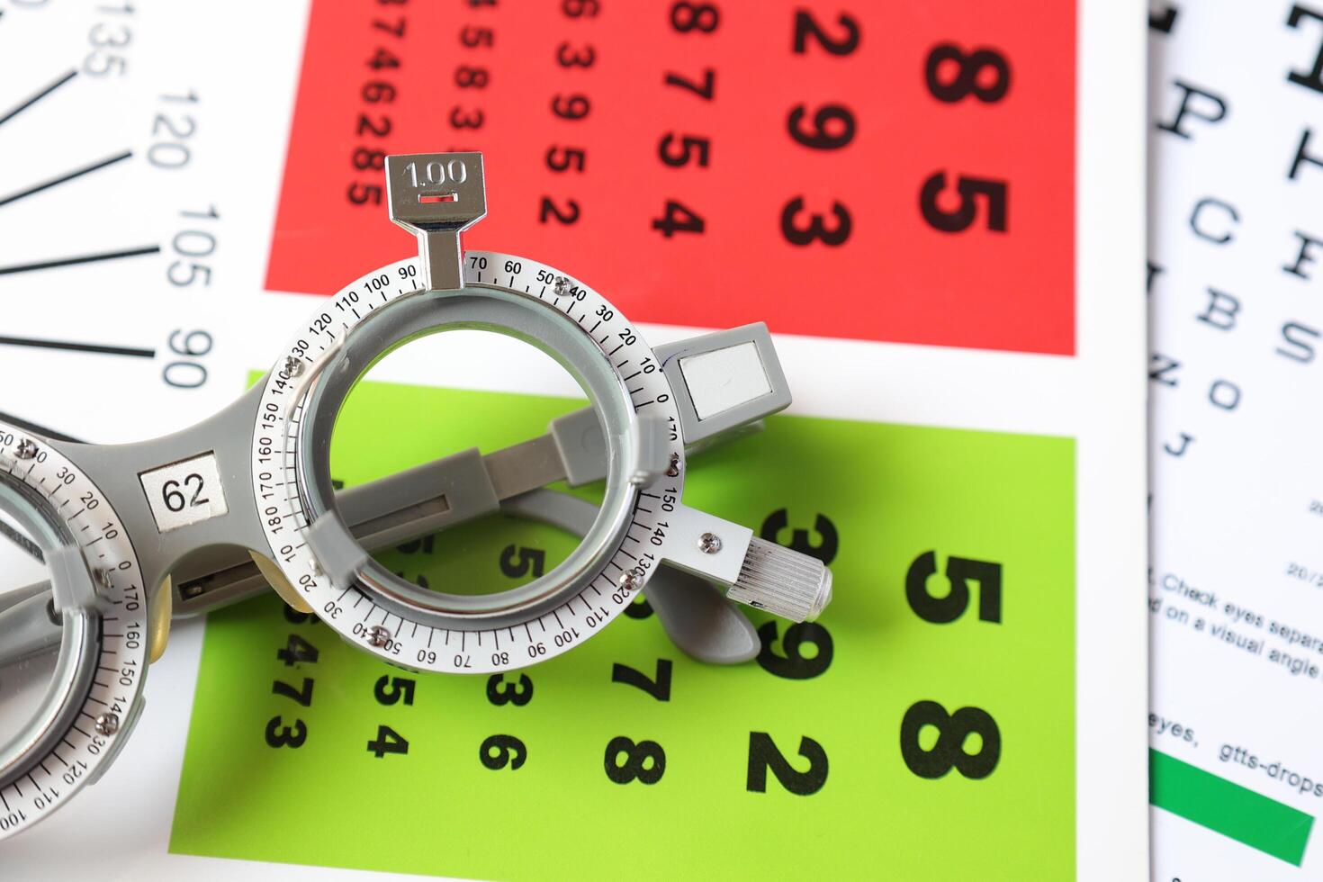 Trial frame glasses for eye test on chart in optical store photo