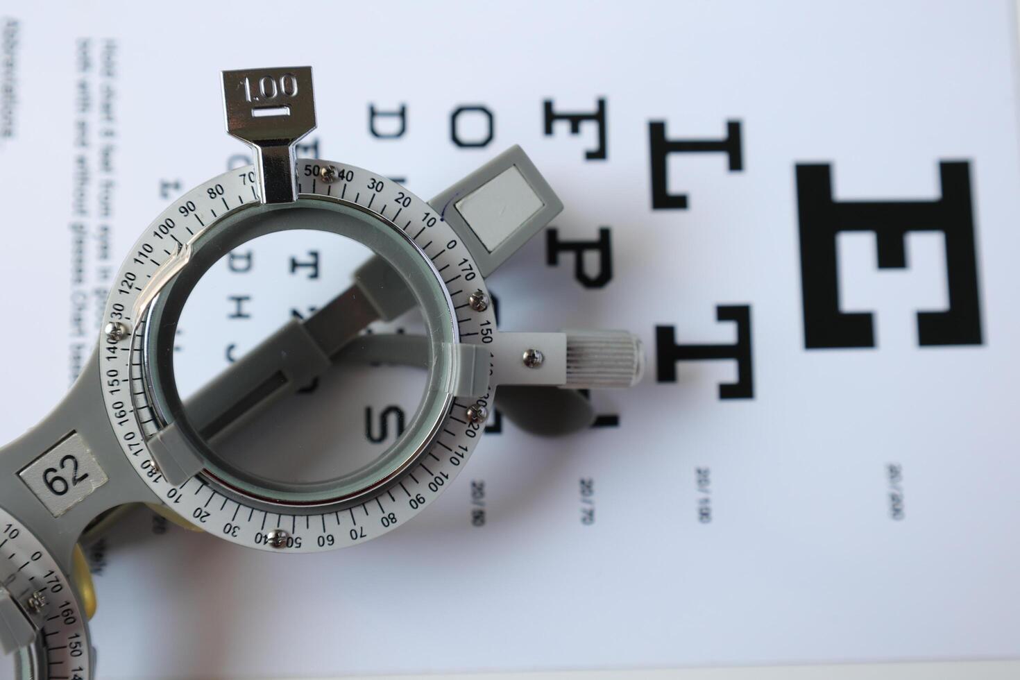 Trial frame glasses for eye test on chart in optical store photo