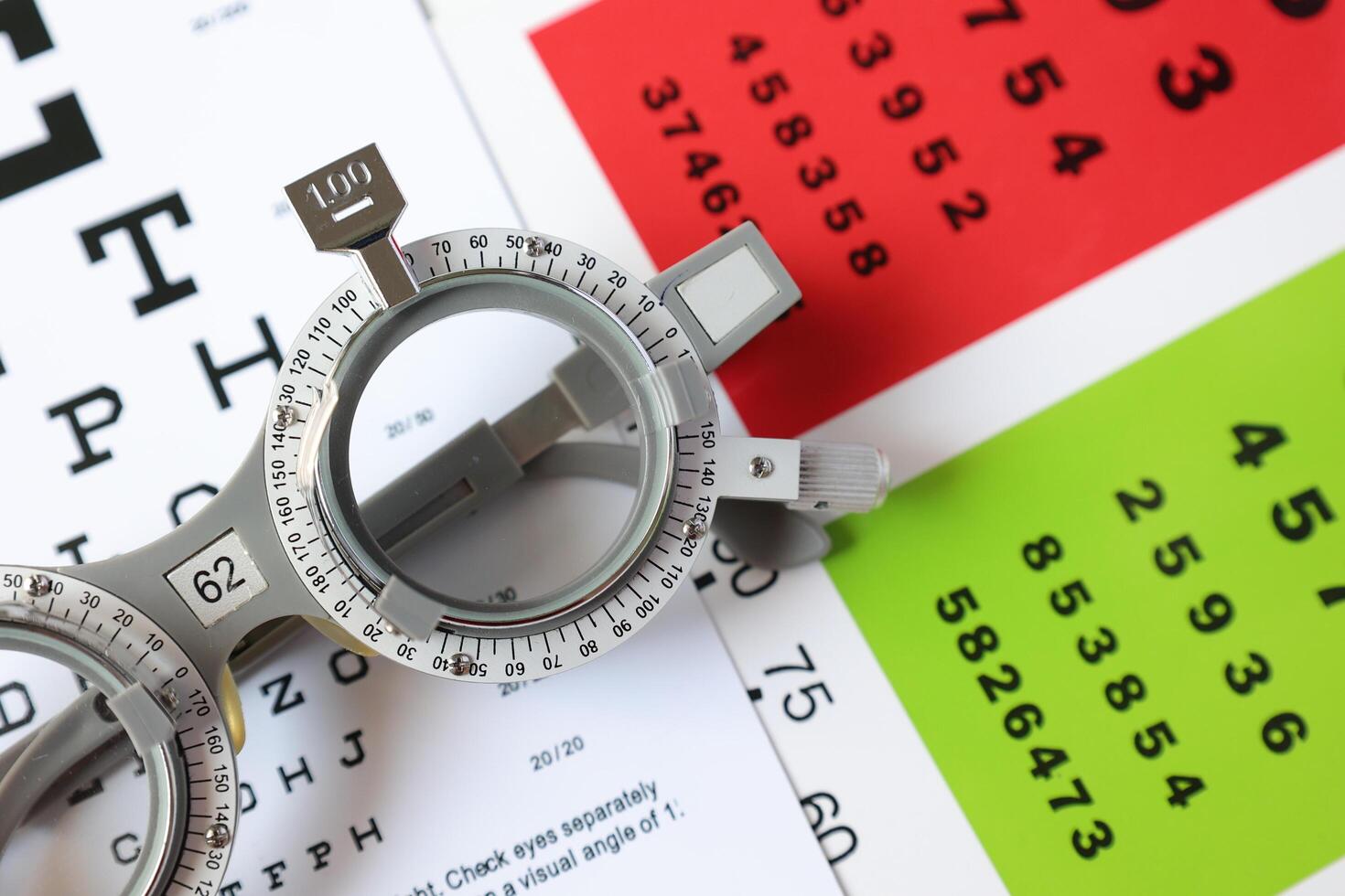 Trial frame glasses for eye test on chart in optical store photo