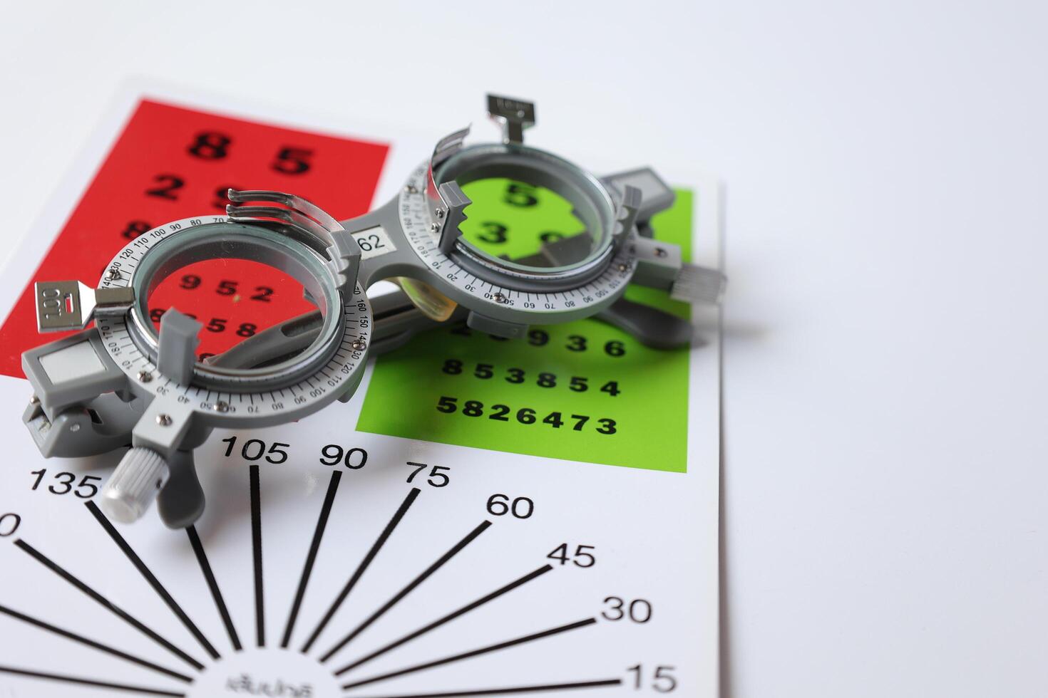 Trial frame glasses for eye test on chart in optical store photo