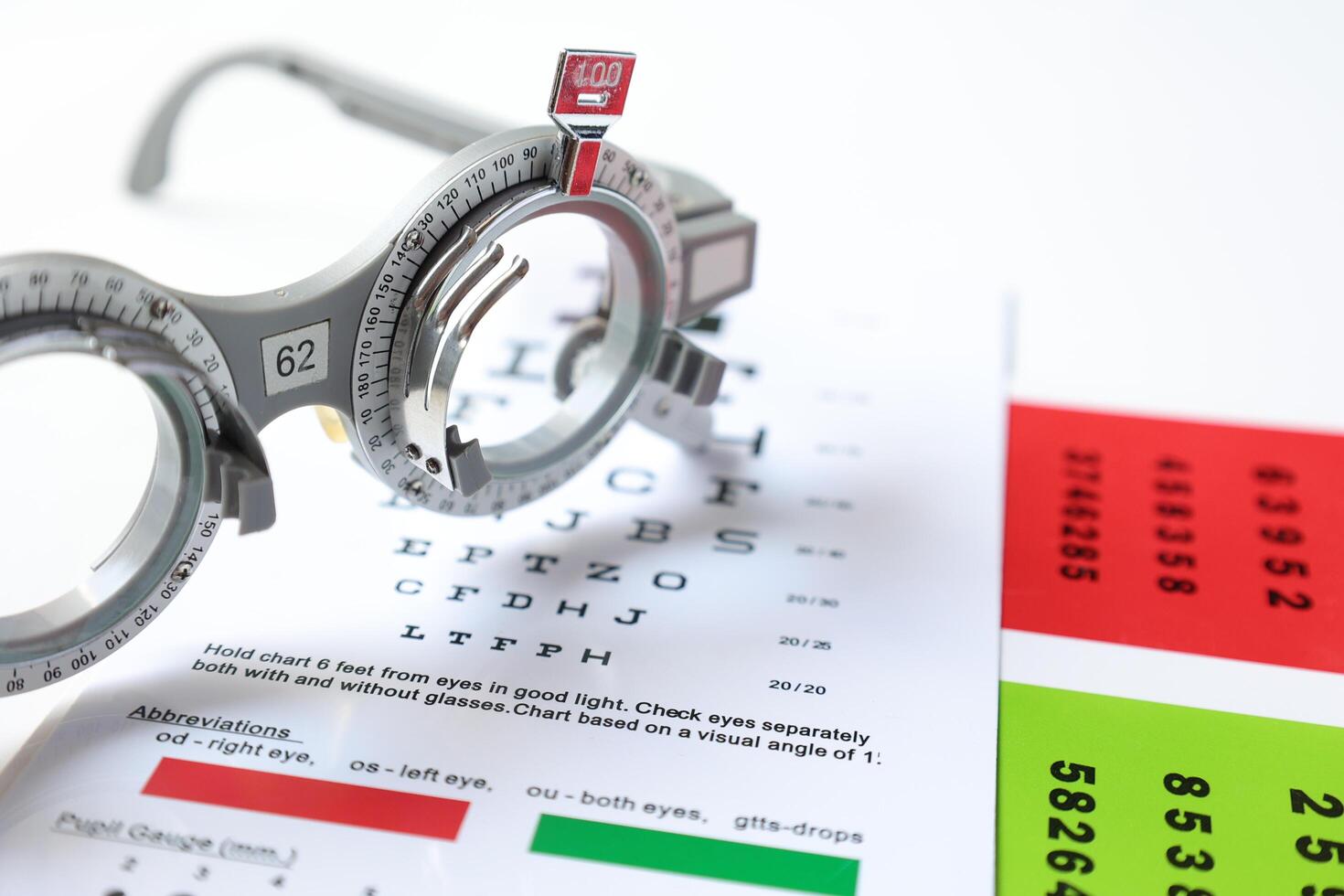 Trial frame glasses for eye test on chart in optical store photo
