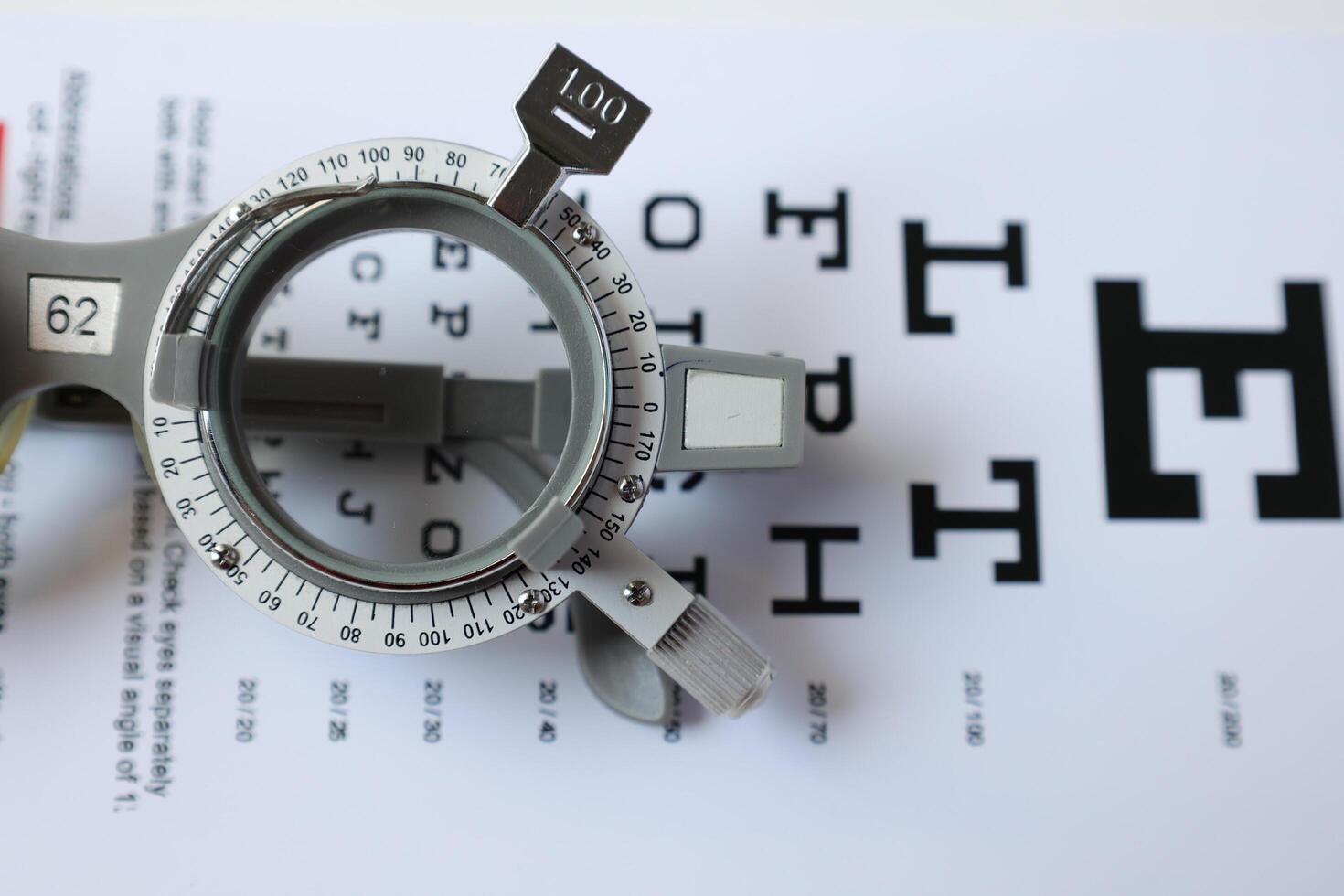 Trial frame glasses for eye test on chart in optical store photo