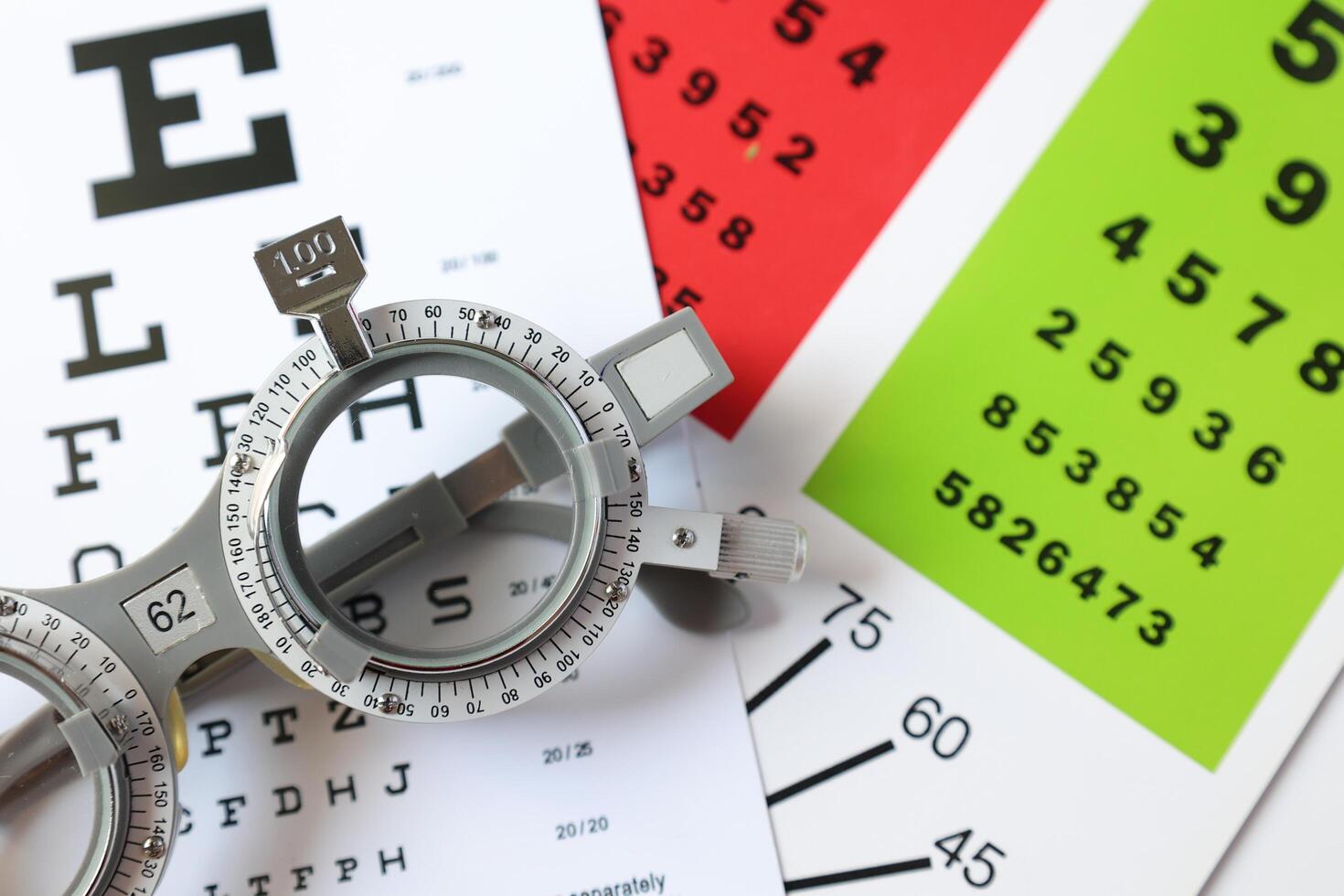 Trial frame glasses for eye test on chart in optical store photo