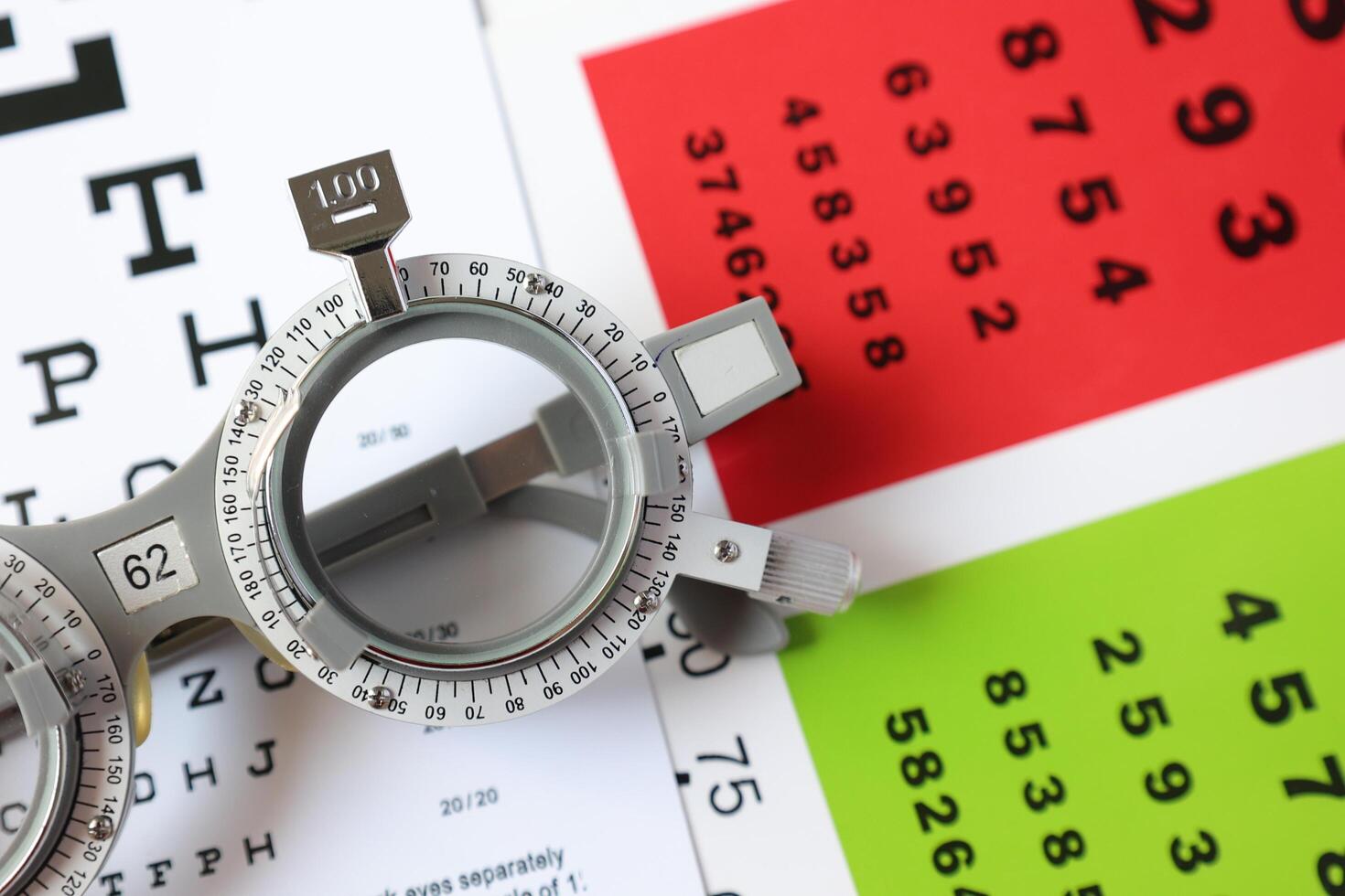 Trial frame glasses for eye test on chart in optical store photo