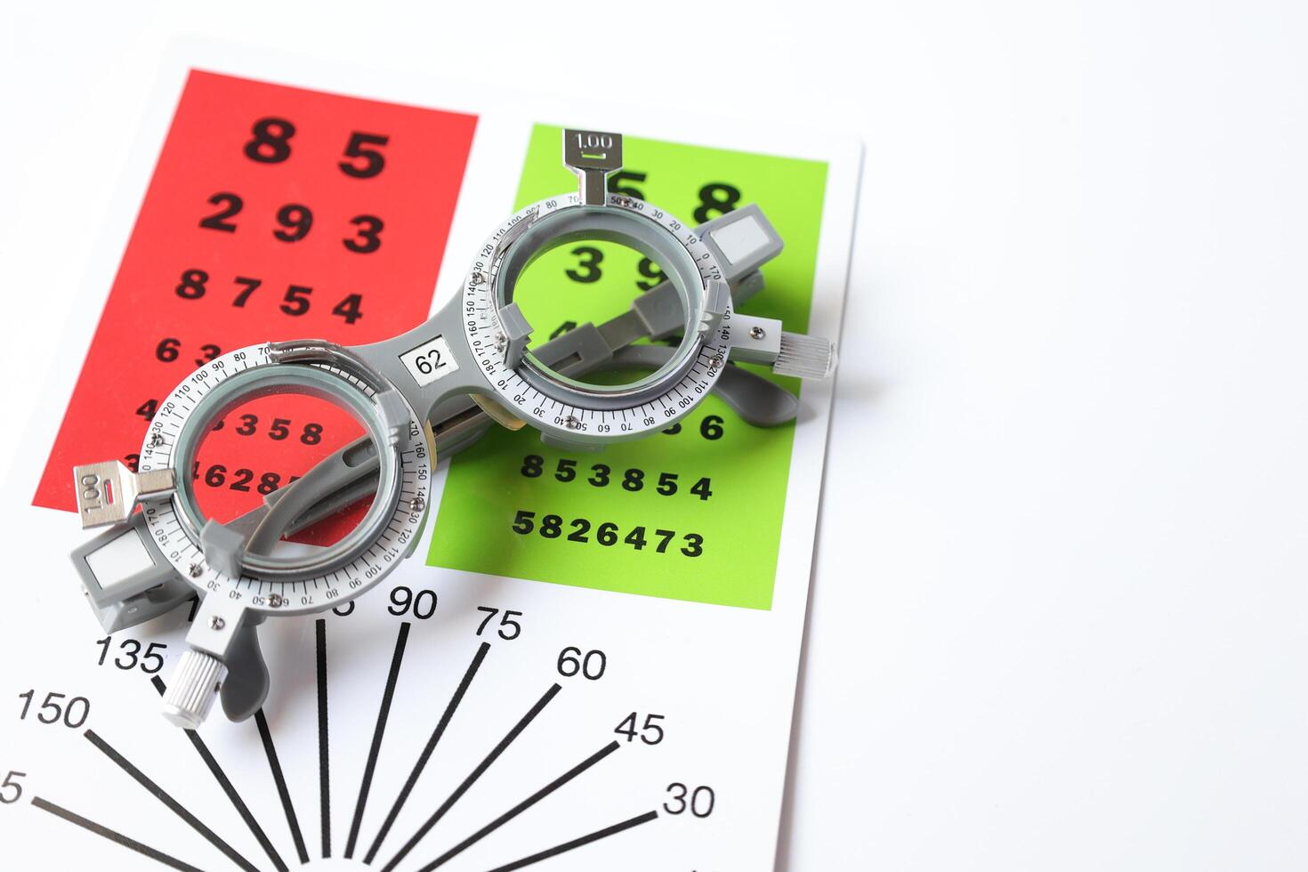 Trial frame glasses for eye test on chart in optical store photo
