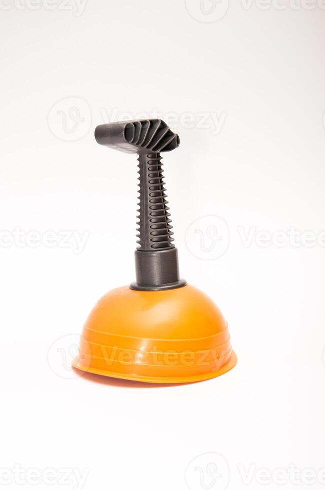 Orange plunger on a white background photo