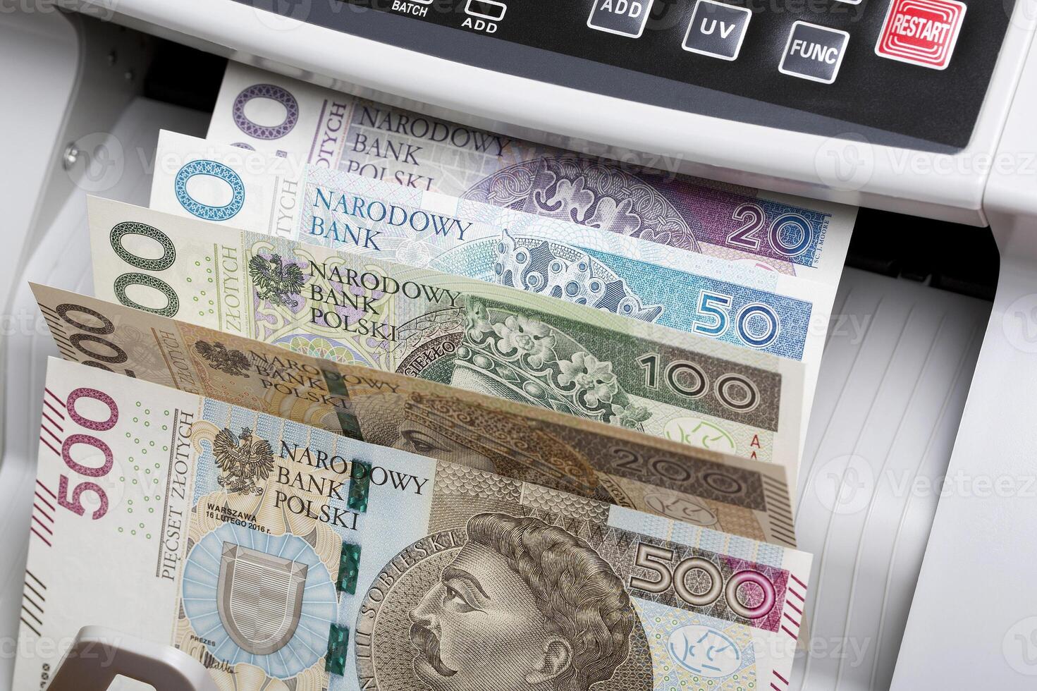 Polish Zloty in a counting machine photo