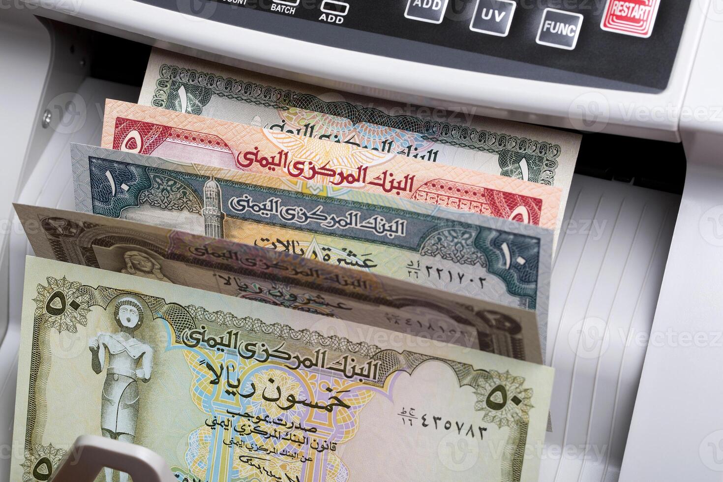 Old Yemeni rial in a counting machine photo