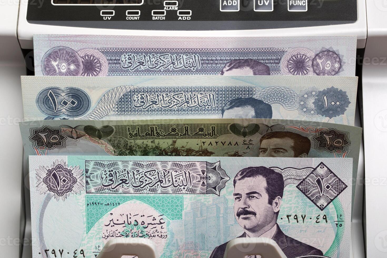 Old Iraqi Dinar in a counting machine photo