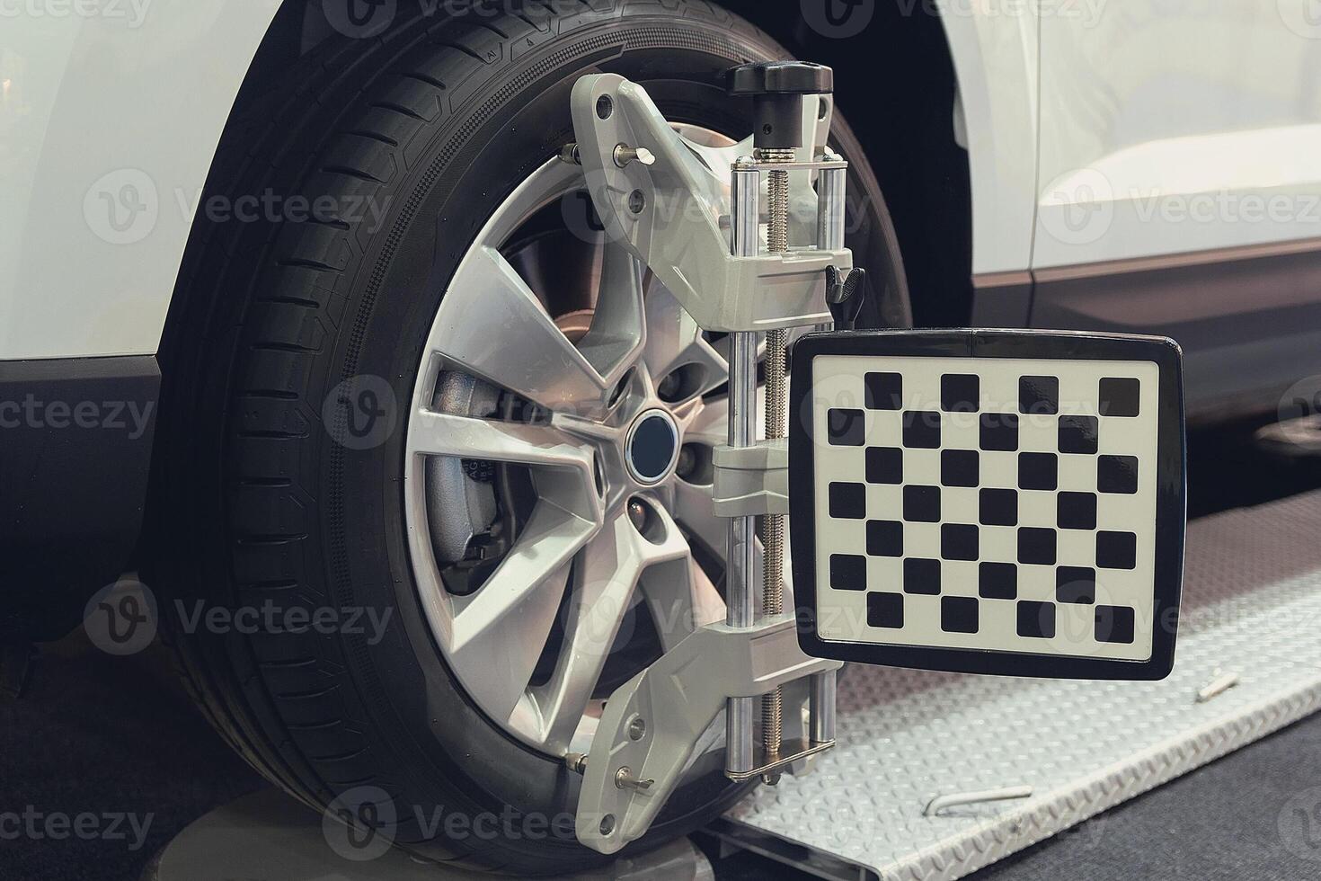 Wheel alignment equipment on a car wheel in a repair station photo