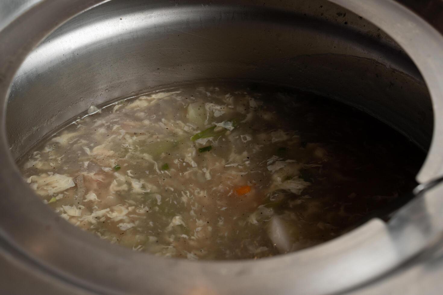 a pot of soup with a spoon in it photo