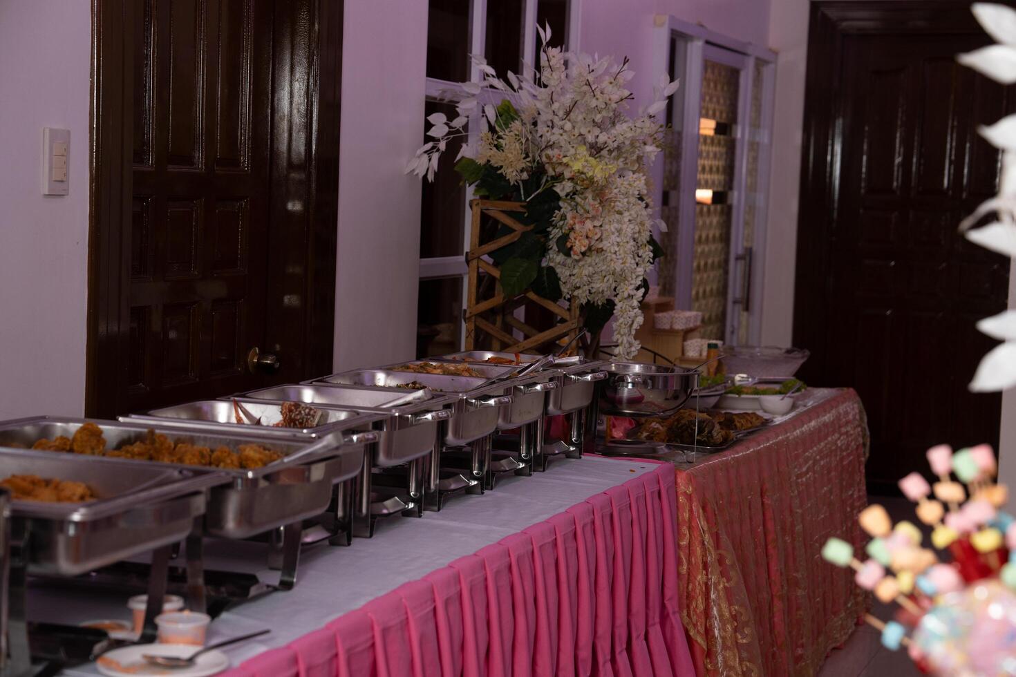 a buffet table with food and flowers photo
