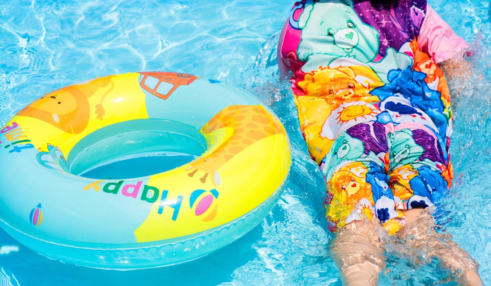 Child in the swimming pool. children playing in the pool. children playing on the beach, or swimming pool on a hot summer day. Kids learn to swim. Child water toys. Children play in tropical resorts. photo
