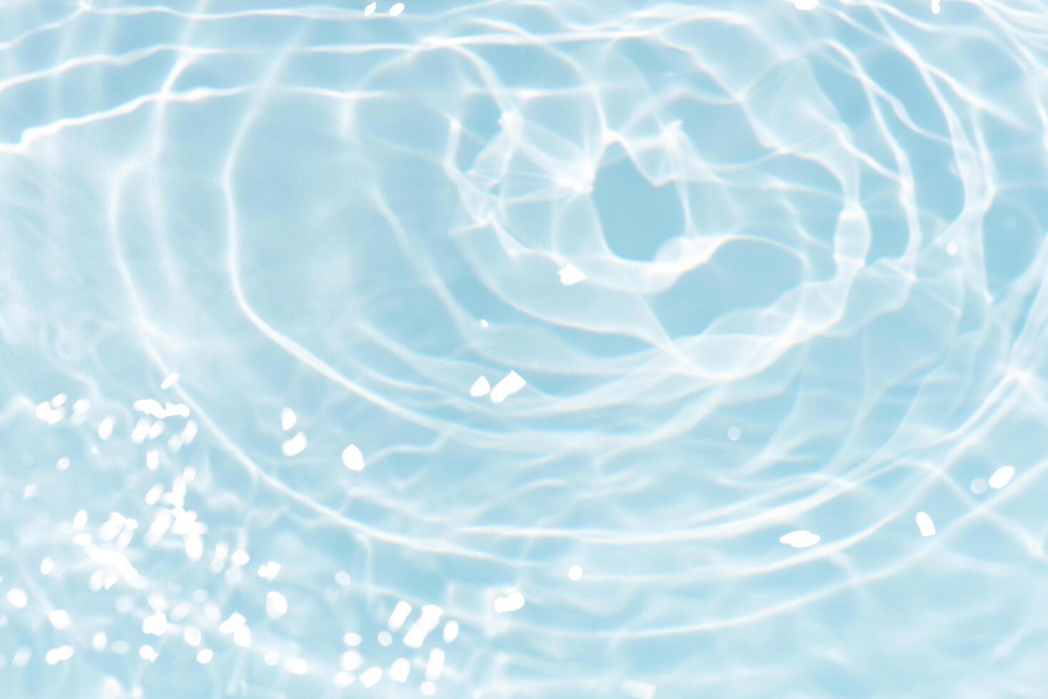 Bluewater waves on the surface ripples blurred. Defocus blurred transparent blue colored clear calm water surface texture with splash and bubbles. Water waves with shining pattern texture background. photo