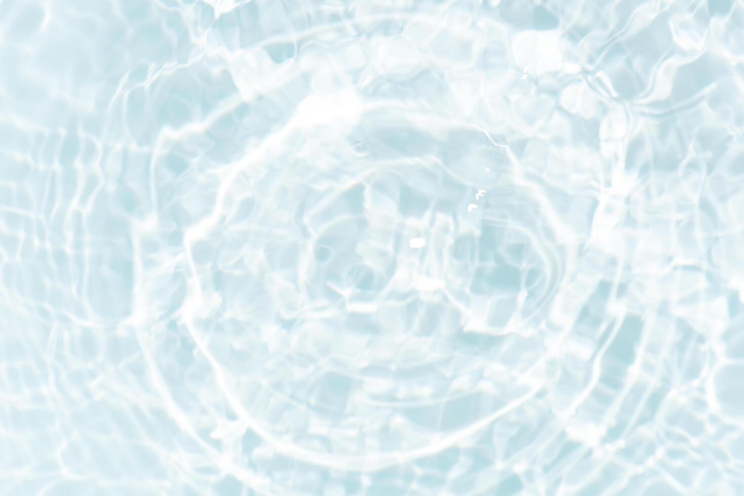 Blue water with ripples on the surface. Defocus blurred transparent blue colored clear calm water surface texture with splashes and bubbles. Water waves with shining pattern texture background. photo