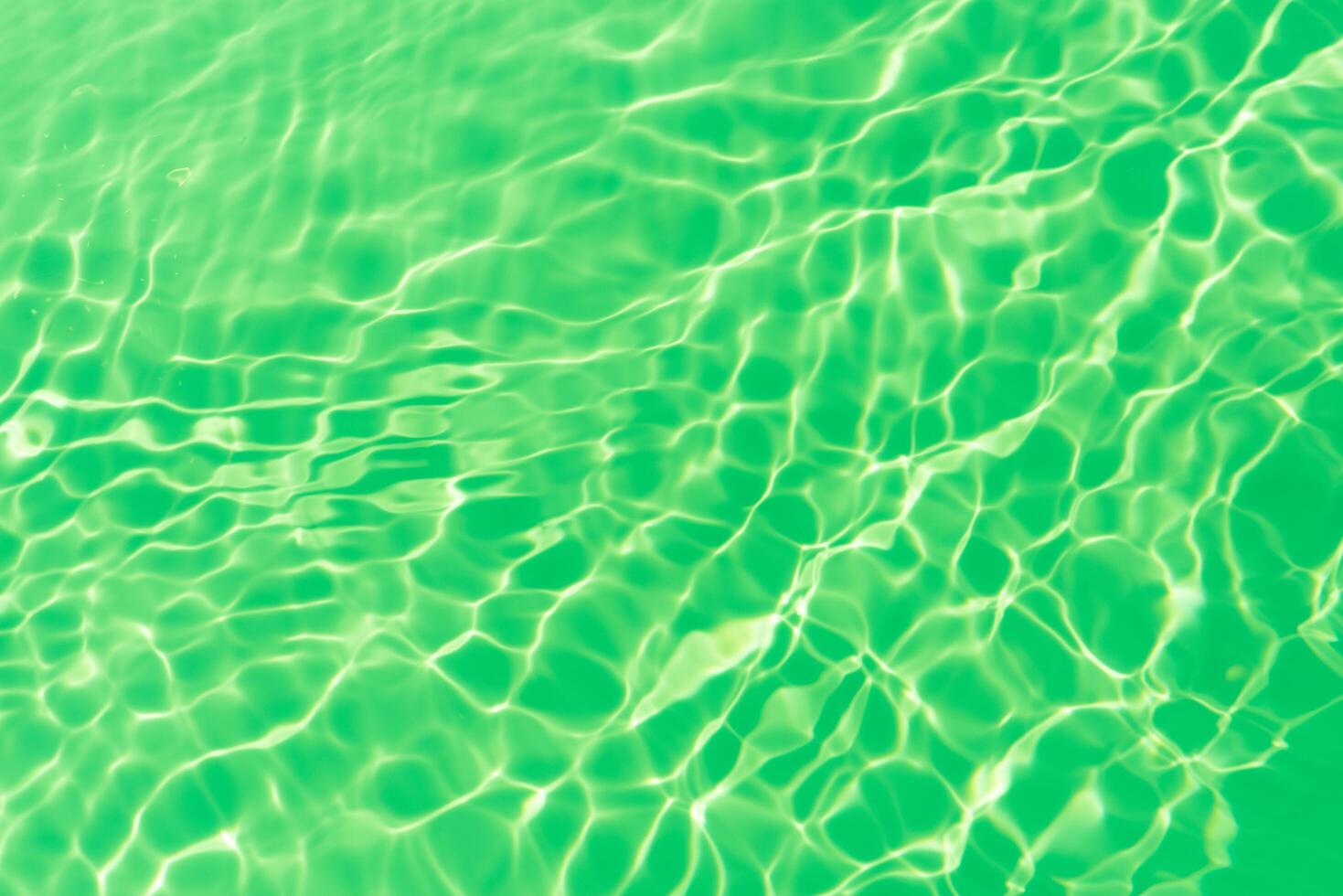 Bluewater waves on the surface ripples blurred. Defocus blurred transparent blue colored clear calm water surface texture with splash and bubbles. Water waves with shining pattern texture background. photo