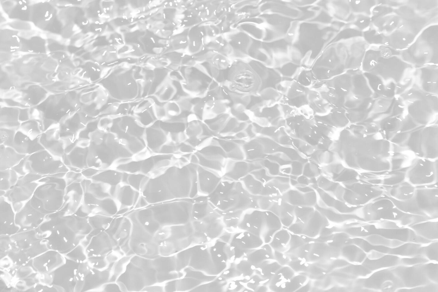 Blue water with ripples on the surface. Defocus blurred transparent blue colored clear calm water surface texture with splashes and bubbles. Water waves with shining pattern texture background. photo