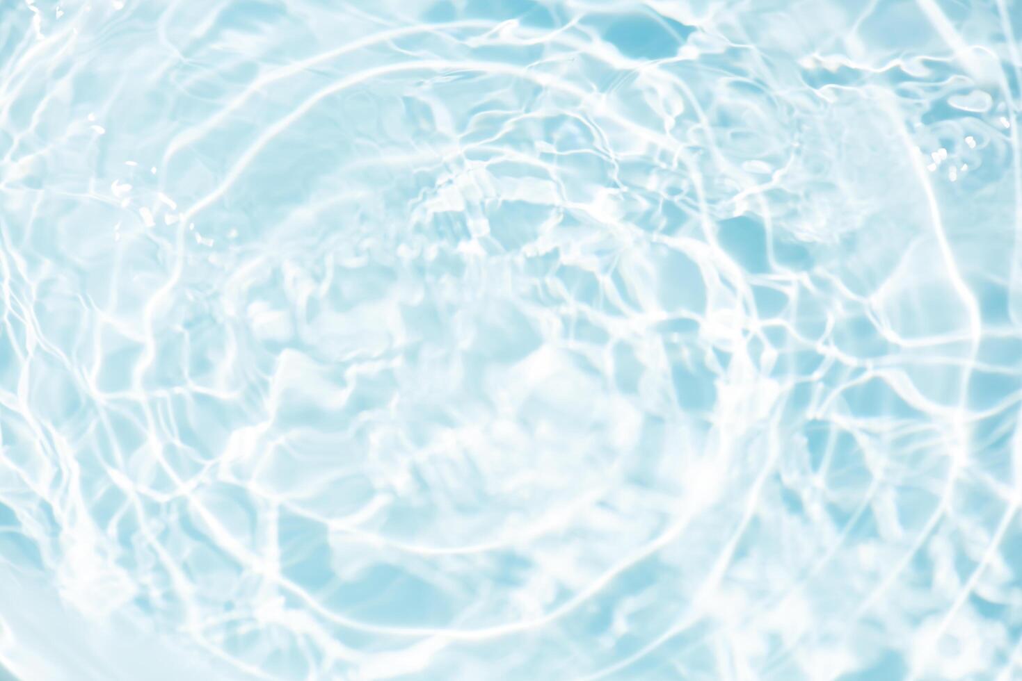 Blue water with ripples on the surface. Defocus blurred transparent blue colored clear calm water surface texture with splashes and bubbles. Water waves with shining pattern texture background. photo