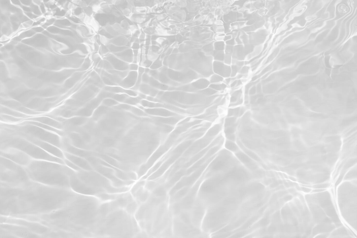 Blue water with ripples on the surface. Defocus blurred transparent blue colored clear calm water surface texture with splashes and bubbles. Water waves with shining pattern texture background. photo