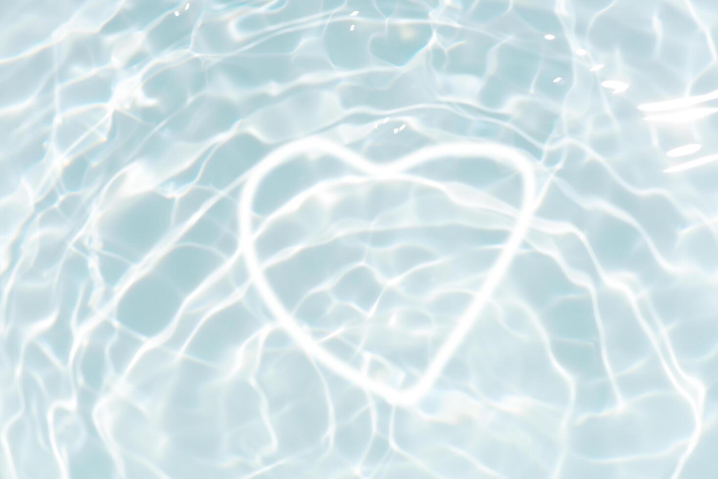 Blue water with ripples on the surface. Defocus blurred transparent blue colored clear calm water surface texture with splashes and bubbles. Water waves with shining pattern texture background. photo