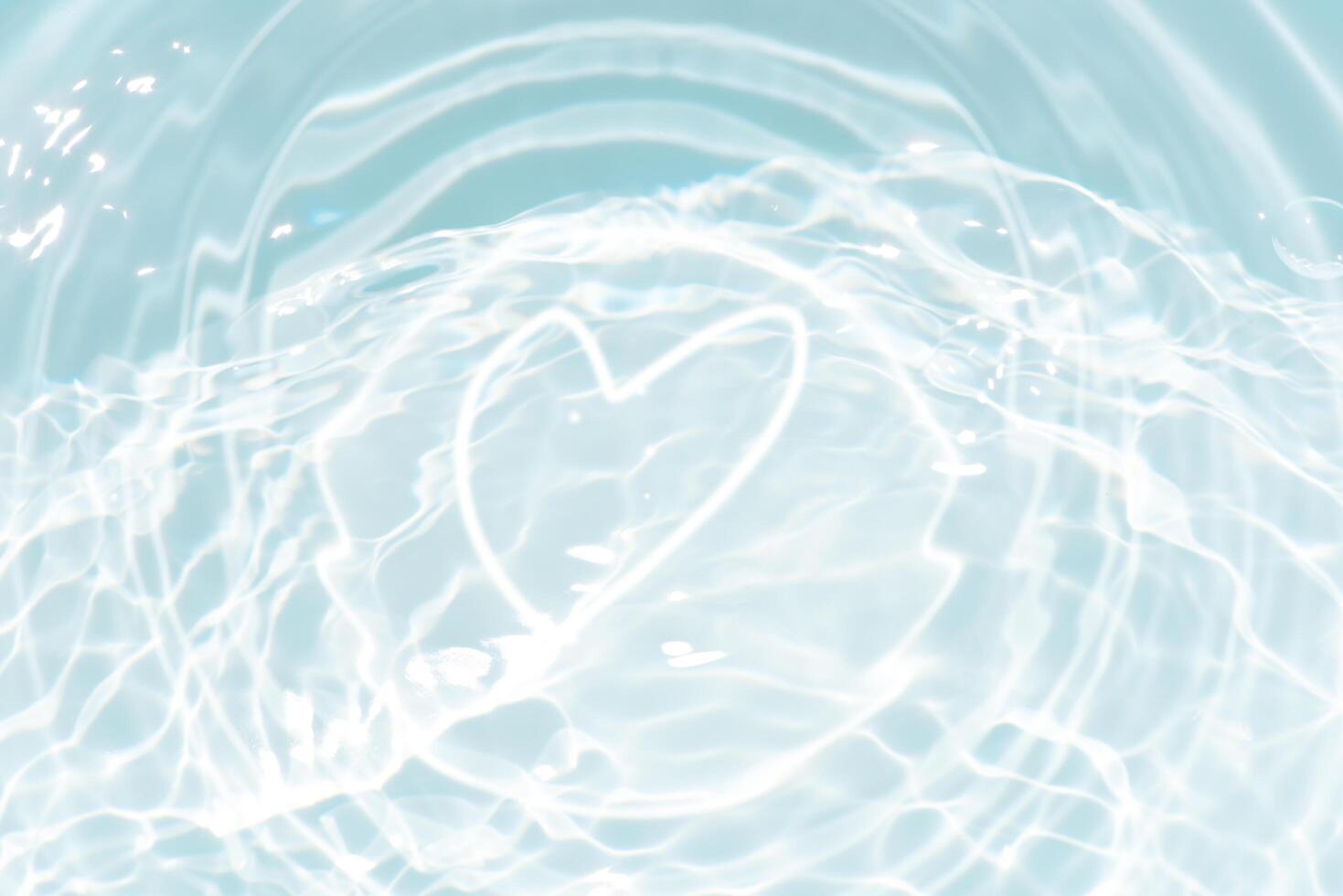 Blue water with ripples on the surface. Defocus blurred transparent blue colored clear calm water surface texture with splashes and bubbles. Water waves with shining pattern texture background. photo
